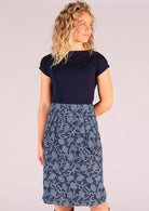 Model wearing Bridgette skirt Neela navy blue 100% cotton retro pencil skirt paired with a navy Wide Neck Mod top