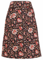 100% cotton knee length pencil skirt in black based floral print with side zipper and piped details across the waist and pocket