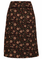 Cotton knee length skirt in black based floral print with wide waistband and small split at middle bottom hem.