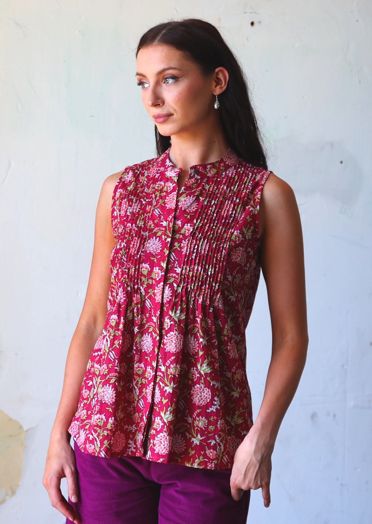 Woman in pink floral cotton sleeveless blouse with high collar