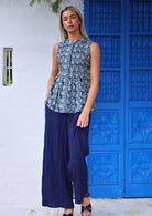 Woman wear sleeveless cotton blue floral print button through blouse with blue wide leg cotton pants