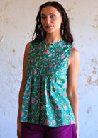 woman wearing green cotton floral sleeveless blouse 