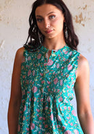 close up of woman wearing green Indian cotton floral sleeveless blouse with beautiful detail on yoke
