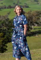 Model with hand in pocket wearing floral print 100 percent cotton dress