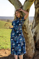 Model wearing Chelsea Dress Gardenia 100 percent cotton shirt dress featuring pockets, waist tie, and collar