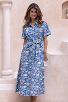 Model in 100 percent cotton dusty blue shirt style dress with fabric belt, short sleeves and pockets