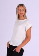 model wearing natural white double cotton cap sleeve top with round neckline