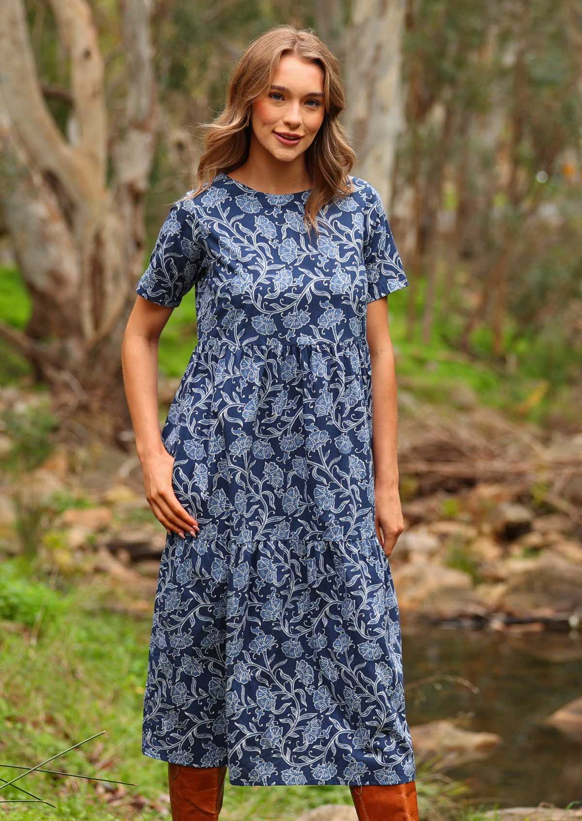 Model with thumb in pocket standing wearing Claudia Dress Neela navy blue 100 percent cotton maxi sundress 