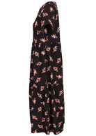 Side view of cotton short sleeved midi length dress with empire waist and tiered skirt in black based floral print 