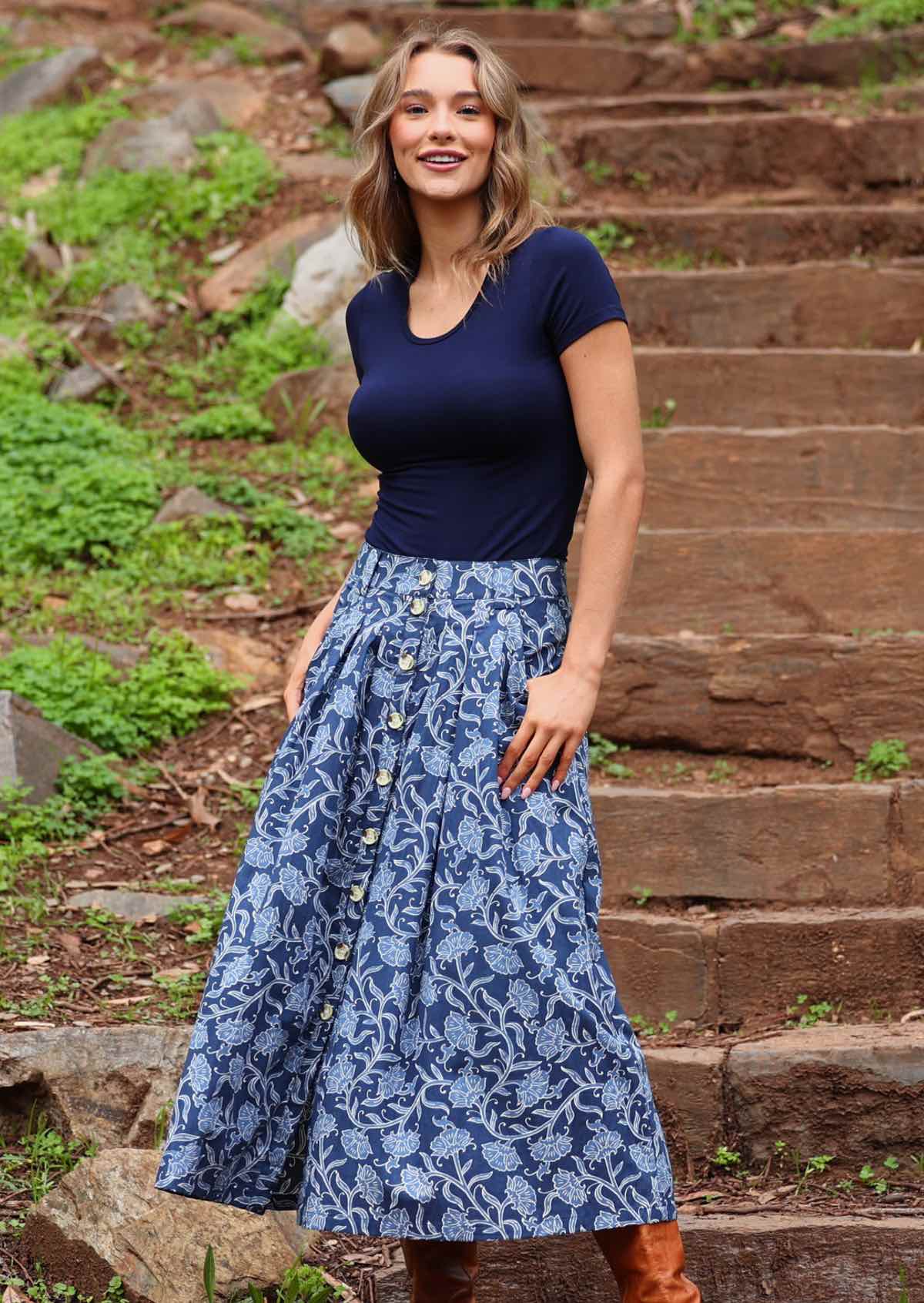 Model wearing Cora Skirt Neela navy button down cotton maxi skirt with thumb in pocket