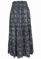 Navy blue based floral print skirt on a white background.