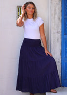 Woman wearing navy blue cotton maxi skirt with elastic waist and white t-shirt 