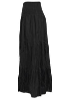 Side view of black cotton flowy tiered maxi skirt with elasticated waistband 