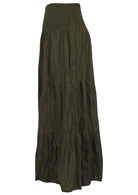 Side view of long cotton skirt in olive green featuring 3 tiered style and shirring across the waist.