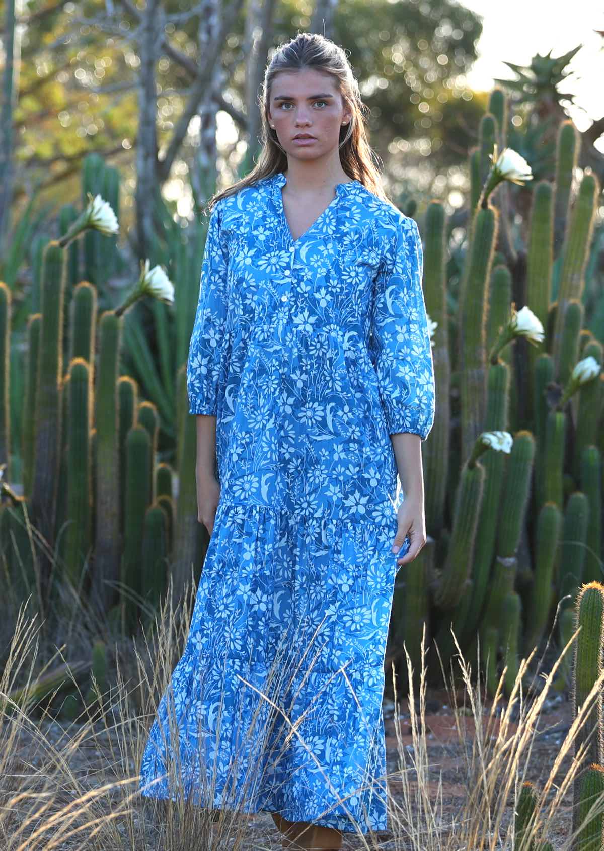 woman in blue cotton maxi dress with light blue and white floral print