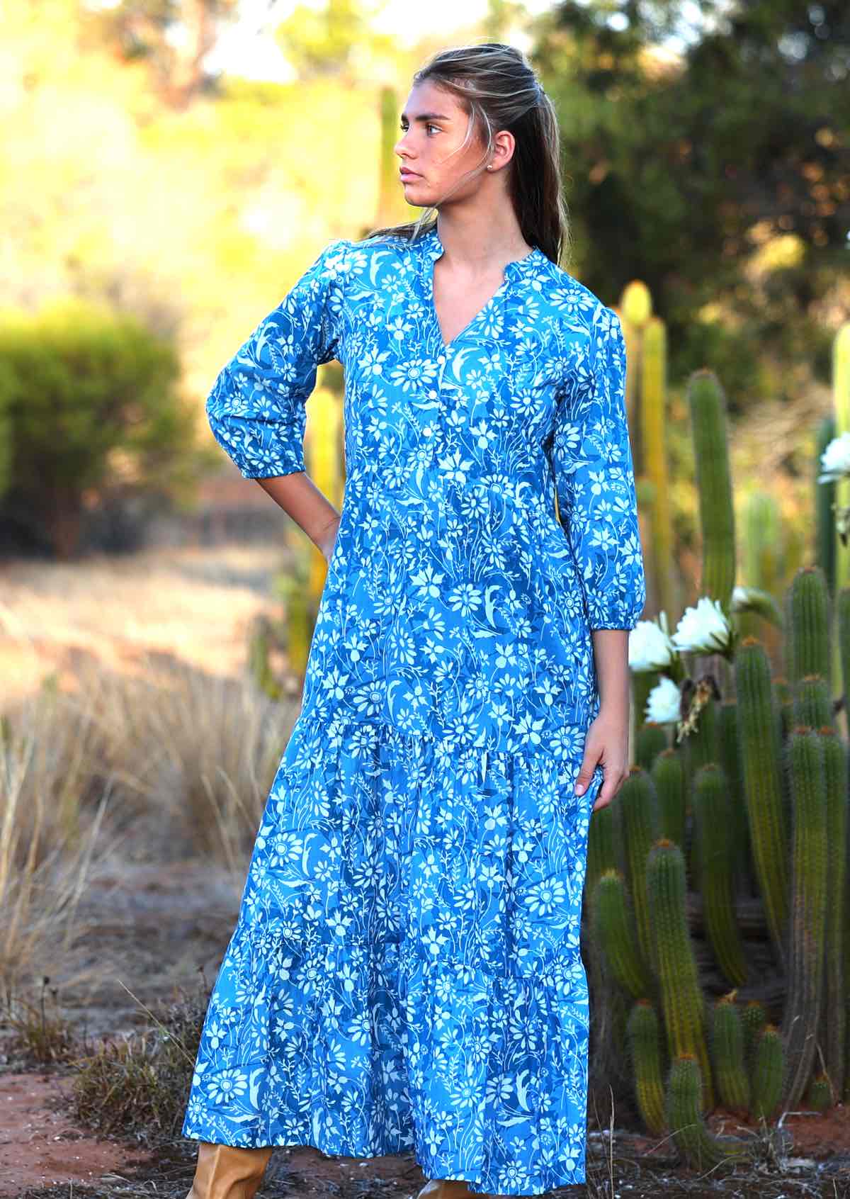 woman in blue cotton maxi dress with light blue and white floral print with long sleeves 