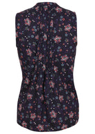 Back view of a cotton sleeveless blouse with a floral print on a dark base. The blouse has a series of vertical pleats down the centre of the back