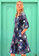 woman with blonde hair in 100% cotton wrap dress in blue with white flowers 