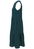 Side view of  the Ember Midi Dress Deep Teal showing the flowing tiered skirt