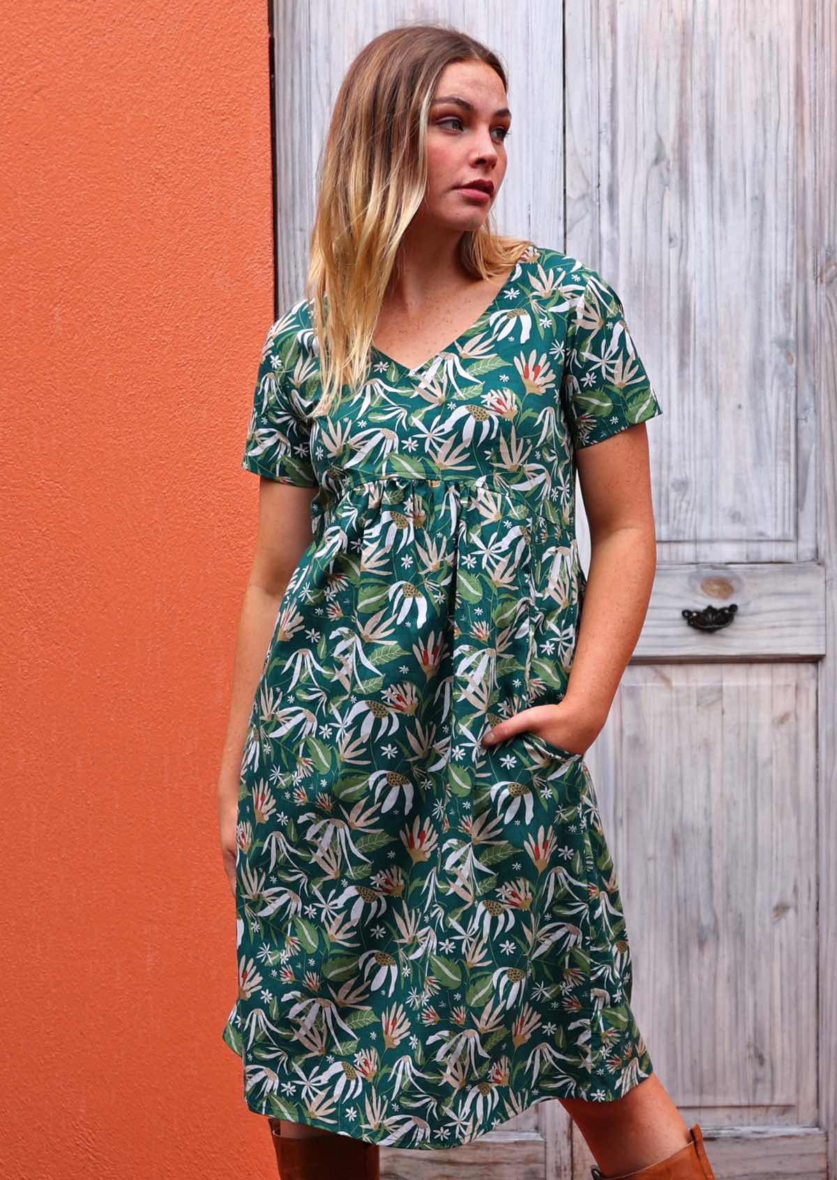 Model standing wearing Etta v-neck Dress Flannel Flower cotton green sundress with hand in pocket