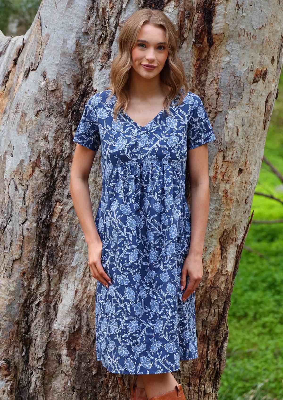 Model standing with thumb in pocket modelling the Etta v-neck Dress Neela cotton sundress with short sleeves 