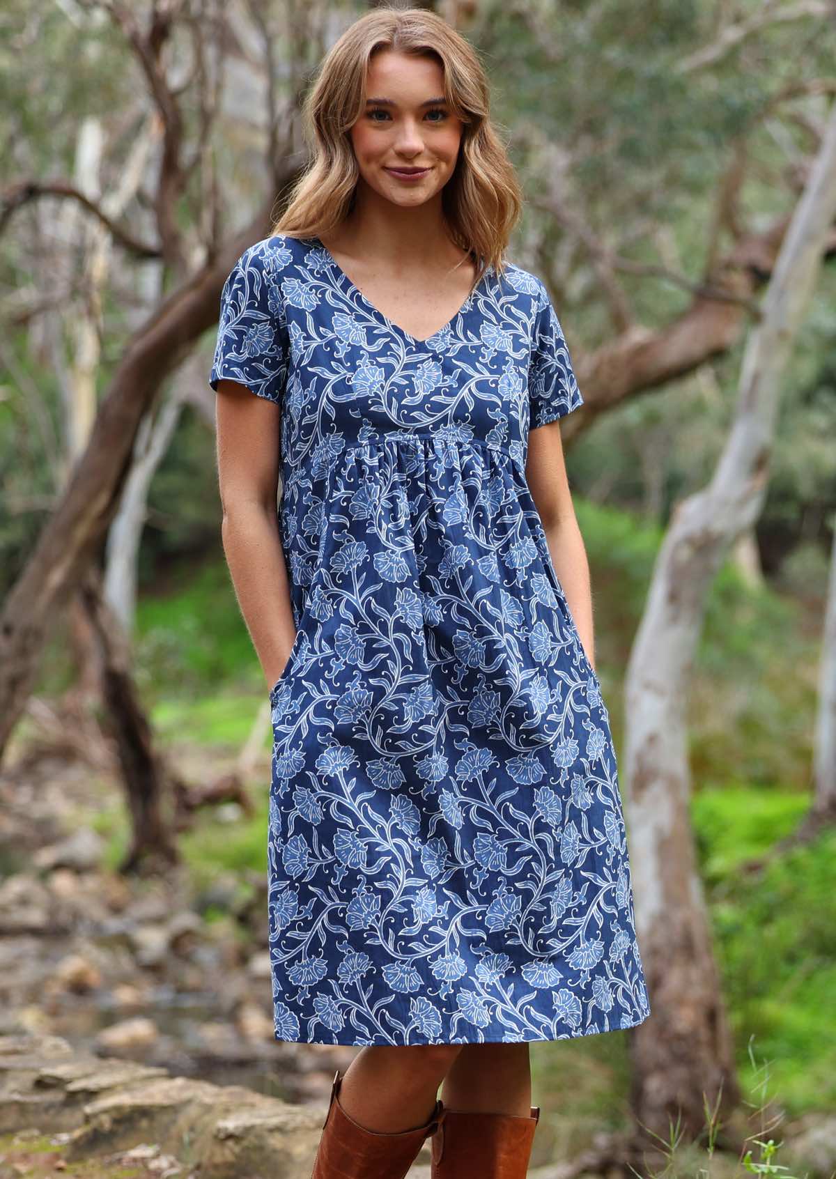 Model standing with hands in pockets modelling the Etta v-neck Dress Neela cotton sundress with short sleeves