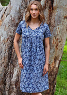 Model standing with thumb in pocket modelling the Etta v-neck Dress Neela cotton sundress with short sleeves