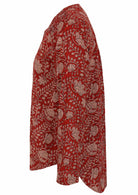 Long sleeve cotton top that is longer at the back with red based floral print