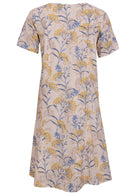Back view of cotton dress with round neckline in neutral based floral print. 
