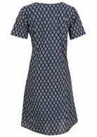 Back view of cotton dress with round neckline in navy blue based floral print. 