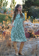 Model wears cotton over the knee relaxed fit dress with empire waistline and pockets