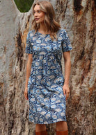 Blue floral cotton sun dress with high round neckline and relaxed fit empire waistline