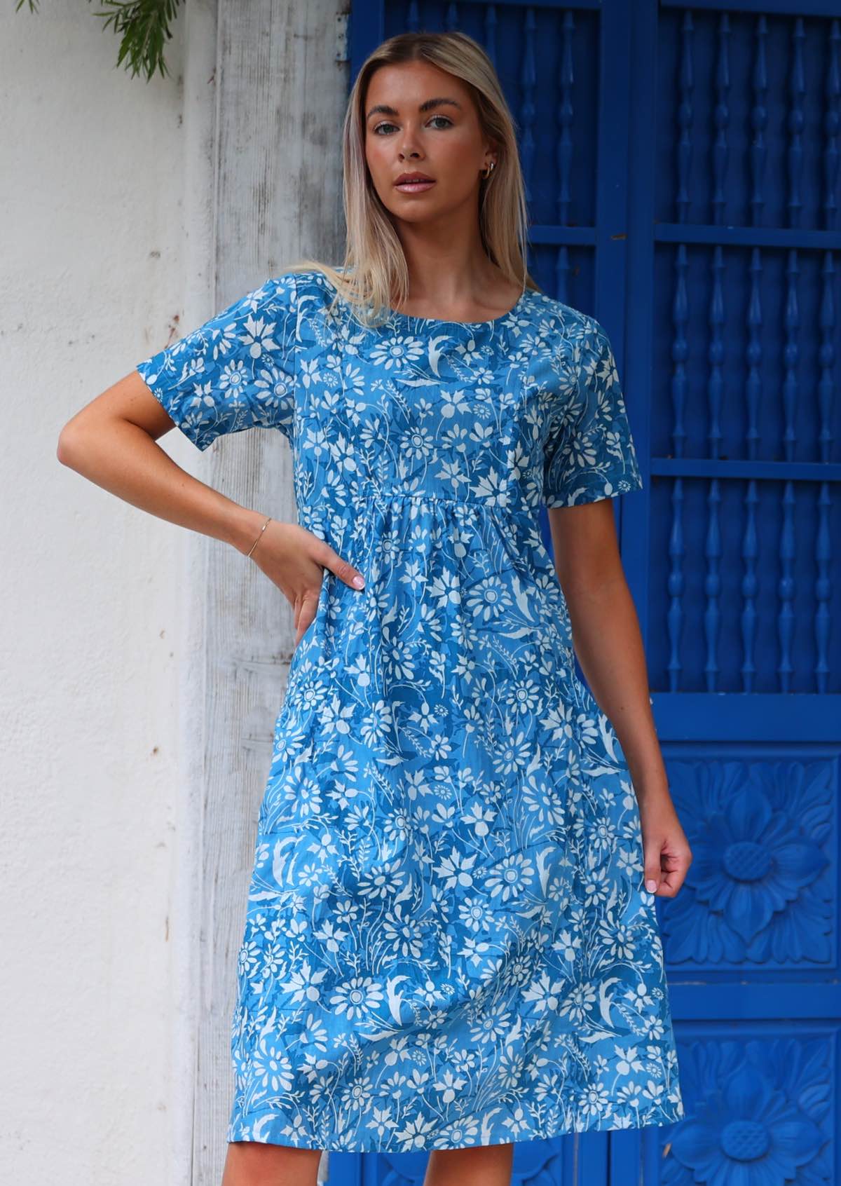 Model wears cotton relaxed fit dress with small gathers under the bust and T-shirt style sleeves