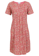Front view of cotton dress with round neckline in rose pink based floral print. 