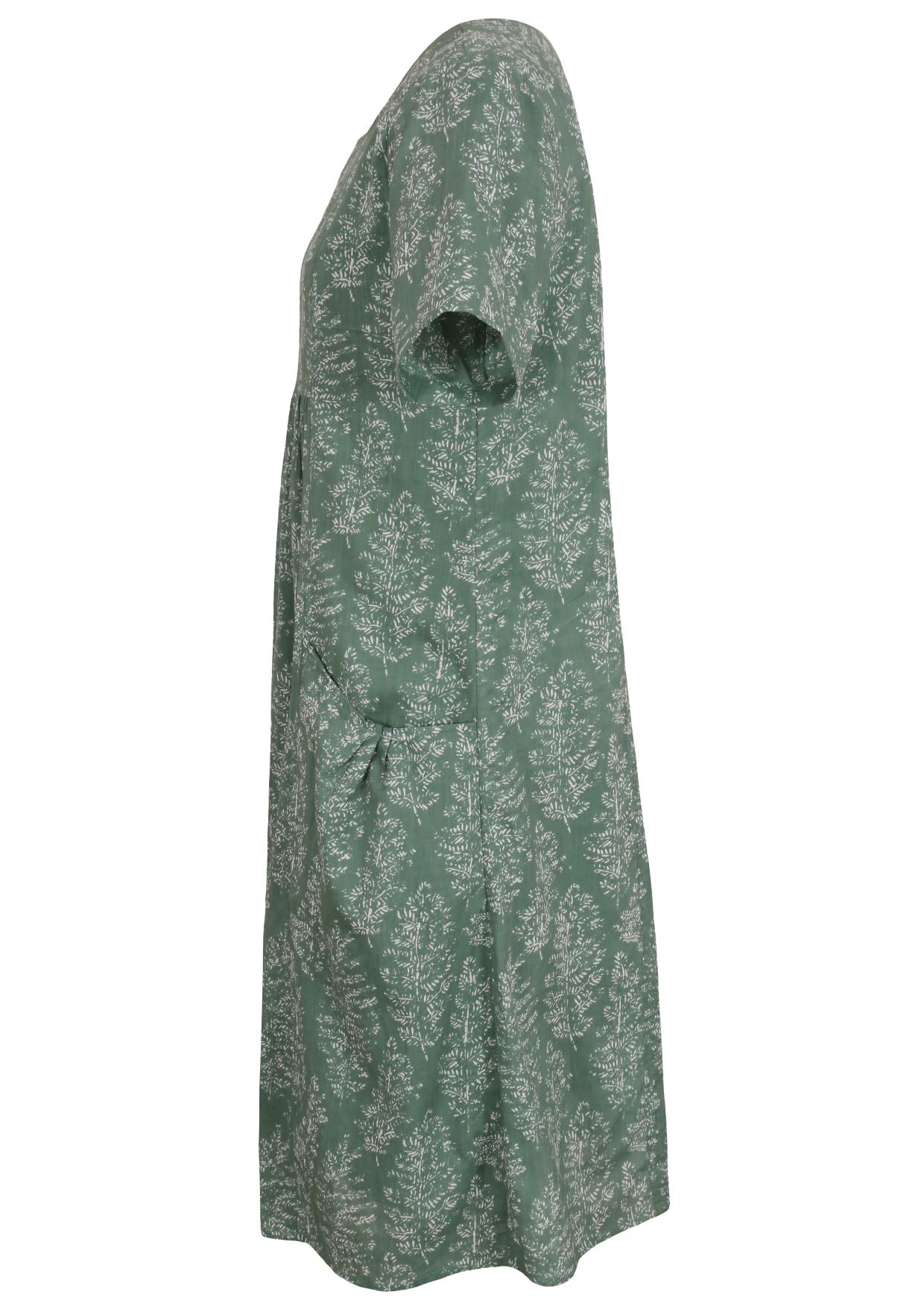 Side view of cotton dress with round neckline and short sleeves in sage green based floral print. 