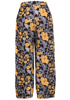 Back view of floral cotton pants with yellow and blue-grey flowers on a black base