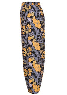 Side view of floral cotton pants with yellow and blue-grey flowers on a black base, with pockets