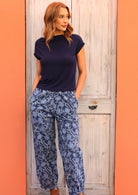 Model wearing Greta Pant Neela navy 100 percent cotton relaxed fit pants with her hands in pockets