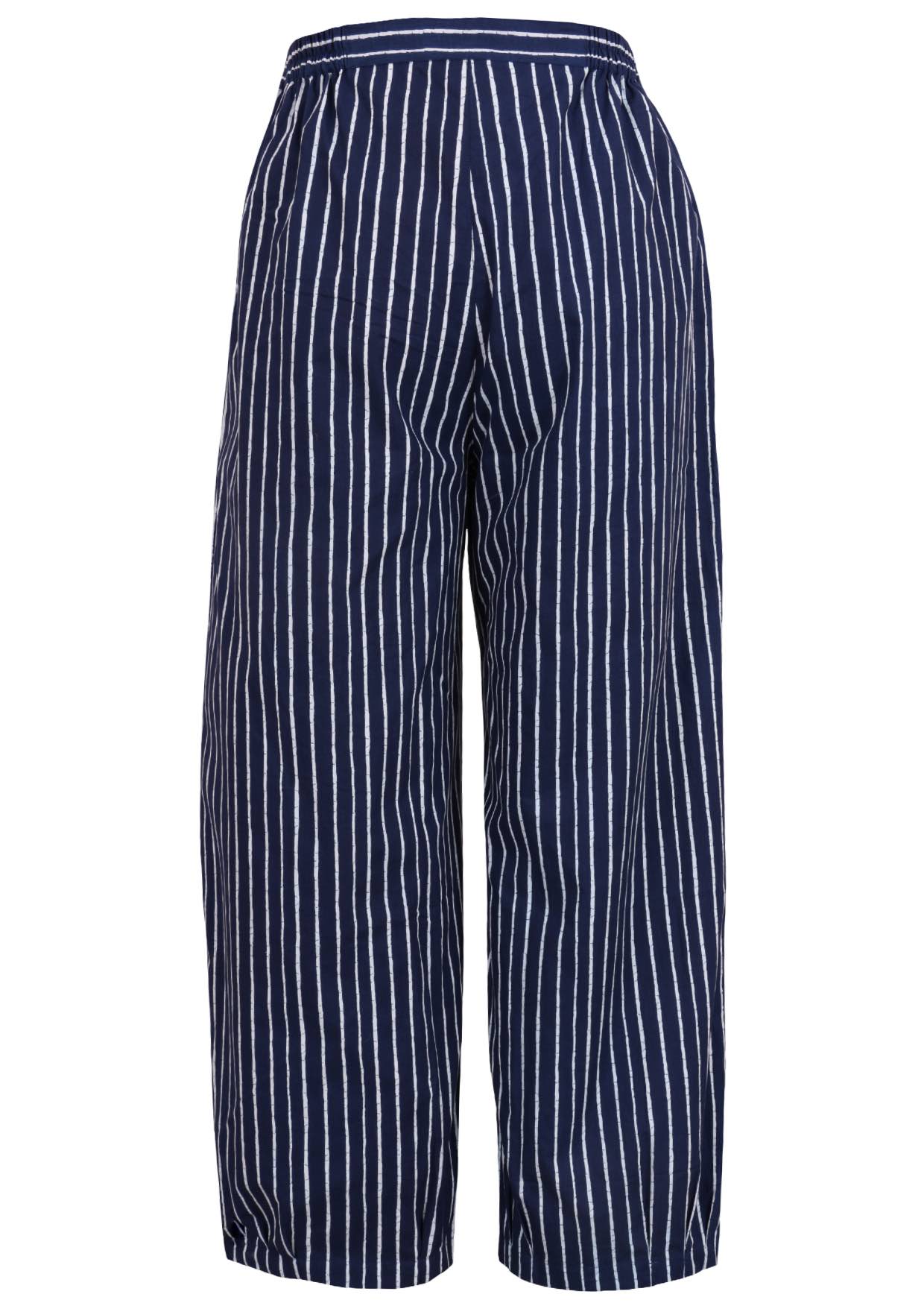 Back view of navy blue based print pants with elastic waist