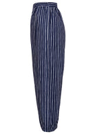 Side view of navy blue based print pants with pockets