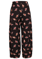 Back view of 100% cotton wide leg pants with elastic waist and pockets in black based floral print