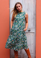 Model standing in front of door wearing Harper dress Flannel Flower 100 percent cotton sleeveless dress with hands in pockets