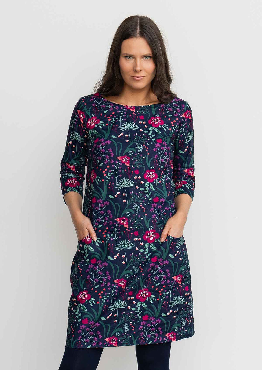 Woman wearing 100% cotton 3/4 sleeve navy shift dress with hands in pockets 