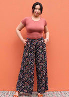 Model wearing black and floral print 100 percent rayon womens palazzo pants