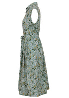 Side view of sage green based floral print cotton dress with pockets.