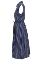 Side view of navy blue based print cotton dress with pockets.