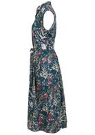 Side view of teal based floral print cotton dress with pockets.