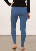 Person wearing blue soft stretch rayon leggings and a black top