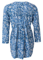 Blue floral button through shirt with long sleeves and pin tucks accross the bodice, front and back, and is longer at the back