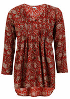 Red based floral print cotton button through shirt with pin tucks across the bodice and a V-neckline